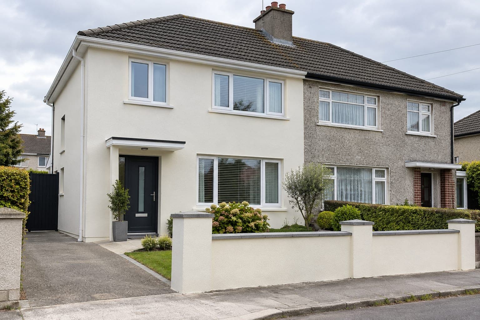 Semi-detached house finished in smooth off-white external wall insulation render, beside an attached neighbour still in older pebbledash